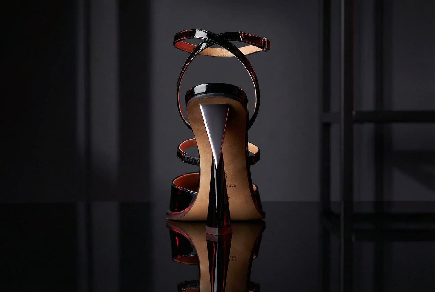 Vanessa Nardulli signature geometric heel detail illuminated in dramatic lighting