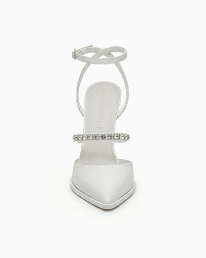 White pointed-toe heels with ankle strap and crystals, front view